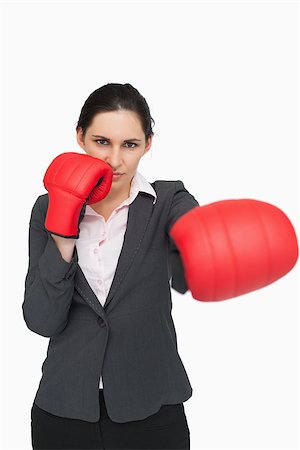 simsearch:400-06876600,k - Serious brunette wearing red gloves while punching against white background Stock Photo - Budget Royalty-Free & Subscription, Code: 400-06803464