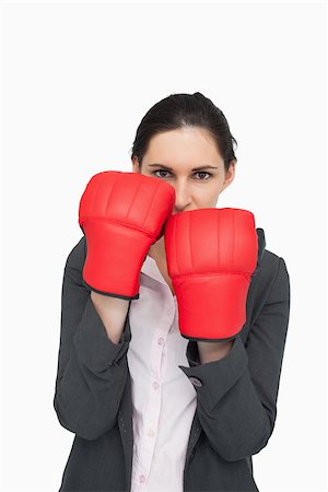 simsearch:400-06876600,k - Combative brunette wearing red gloves against white background Stock Photo - Budget Royalty-Free & Subscription, Code: 400-06803460