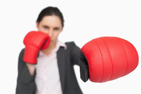simsearch:400-06876600,k - Serious brunette wearing red gloves punching against white background Stock Photo - Budget Royalty-Free & Subscription, Code: 400-06803462