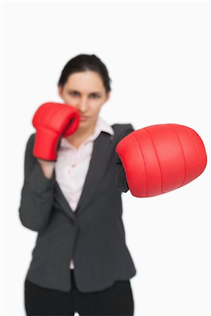 simsearch:400-06876600,k - Brunette wearing red gloves punching against white background Stock Photo - Budget Royalty-Free & Subscription, Code: 400-06803463