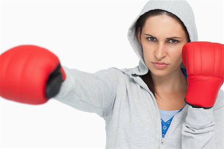 Stern woman in sweatshirt boxing against white background Stock Photo - Budget Royalty-Free & Subscription, Code: 400-06803478