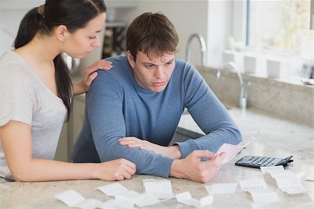 Couple calculating bills in kitchen looking worried Stock Photo - Budget Royalty-Free & Subscription, Code: 400-06803519