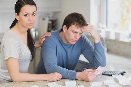 Two people in the kitchen calculating finances with calculator Stock Photo - Budget Royalty-Free & Subscription, Code: 400-06803521