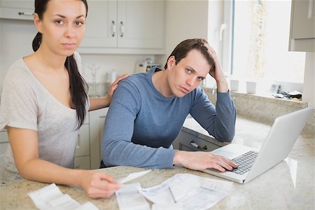 simsearch:400-06803524,k - Two people focused on finances while working on the laptop in the kitchen Stock Photo - Budget Royalty-Free & Subscription, Code: 400-06803531