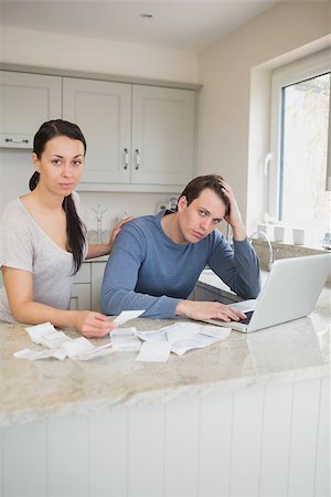 simsearch:400-06803524,k - Two people working on finances while using the laptop in the kitchen Stock Photo - Budget Royalty-Free & Subscription, Code: 400-06803532