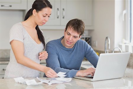 simsearch:400-06803524,k - Two people working on finances and using the laptop in the kitchen Stock Photo - Budget Royalty-Free & Subscription, Code: 400-06803533