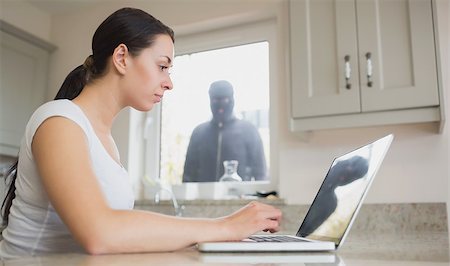 simsearch:400-06803573,k - Young woman seeing reflection of robber in laptop screen Stock Photo - Budget Royalty-Free & Subscription, Code: 400-06803560