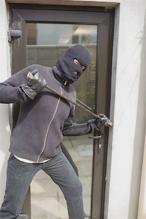 simsearch:400-06803573,k - Burglar breaking into home using crow bar through back door Stock Photo - Budget Royalty-Free & Subscription, Code: 400-06803570