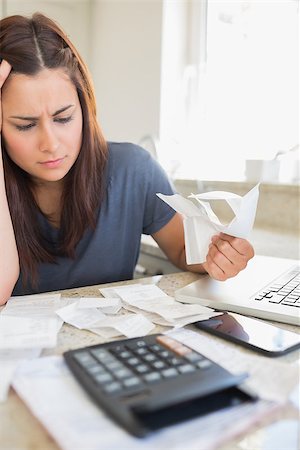 simsearch:400-06803524,k - Brunette looking worried and holding bills in kitchen Stock Photo - Budget Royalty-Free & Subscription, Code: 400-06803666