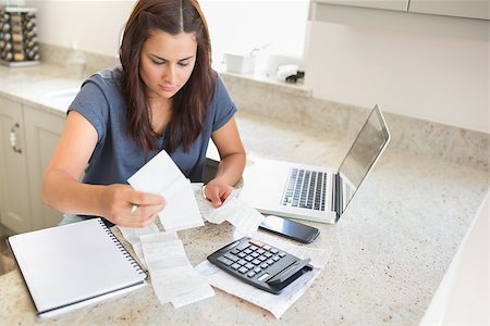 simsearch:400-06803524,k - Woman calculating bills with laptop in ktichen Stock Photo - Budget Royalty-Free & Subscription, Code: 400-06803661