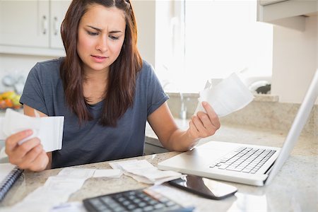 simsearch:400-06803524,k - Young woman getting stressed over finances in kitchen Stock Photo - Budget Royalty-Free & Subscription, Code: 400-06803663