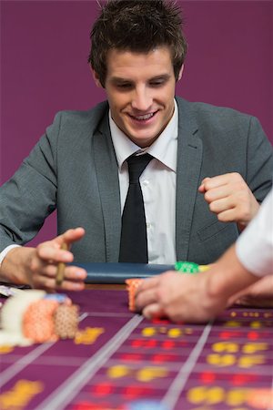 Man happy with his winnings at roulette table Stock Photo - Budget Royalty-Free & Subscription, Code: 400-06803725