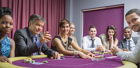 Smiling group at poker table in casino Foto de stock - Super Valor sin royalties y Suscripción, Código: 400-06803731