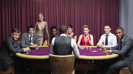 Smiling group sitting around poker table in casino Stock Photo - Budget Royalty-Free & Subscription, Code: 400-06803766