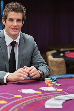 Man sitting at the casino table smiling Stock Photo - Budget Royalty-Free & Subscription, Code: 400-06803771