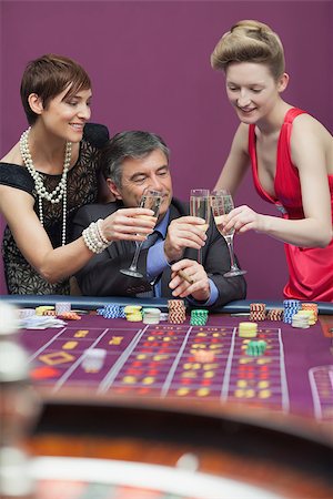 simsearch:400-06802091,k - Women and man clinking glasses at the casino Stock Photo - Budget Royalty-Free & Subscription, Code: 400-06803793