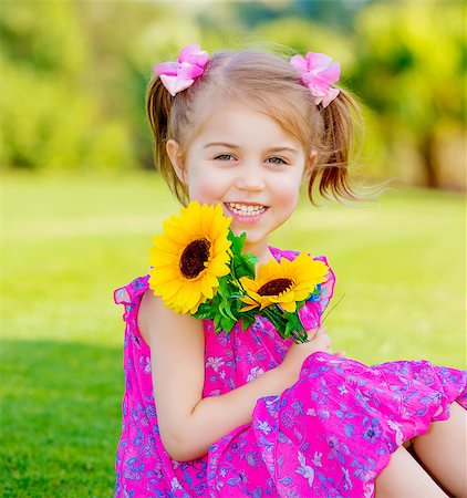 Happy baby girl playing outdoor, cute child holding fresh sunflower flowers, kid having fun in summer park, lovely smiling toddler portrait, enjoying nature of garden Stock Photo - Budget Royalty-Free & Subscription, Code: 400-06847689