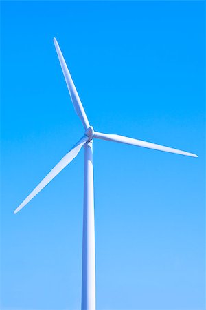 simsearch:400-07111713,k - Wind turbine set against a blue sky Stockbilder - Microstock & Abonnement, Bildnummer: 400-06847771