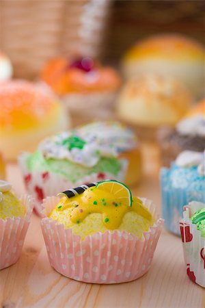 paper cups decorated - lemon cupcakes muffins with cream fuits , breads, chocolate variety and with plenty of decorations Stock Photo - Budget Royalty-Free & Subscription, Code: 400-06848022