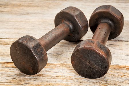 simsearch:400-07620929,k - a pair of vintage iron rusty dumbbells on white painted barn wood background - fitness concept Stock Photo - Budget Royalty-Free & Subscription, Code: 400-06855500