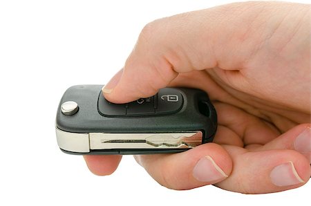 Closeup of male hand holding car key. isolated over white background. Stock Photo - Budget Royalty-Free & Subscription, Code: 400-06855792