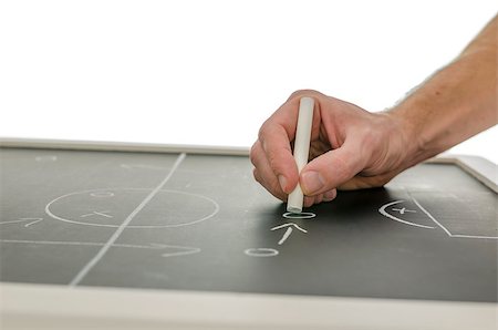 Side view of a hand writing a soccer game strategy on a blackboard. Over white background. Stock Photo - Budget Royalty-Free & Subscription, Code: 400-06855829