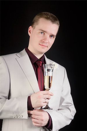 simsearch:400-04171391,k - young attractive man in a suit with a glass of champagne Stock Photo - Budget Royalty-Free & Subscription, Code: 400-06855878
