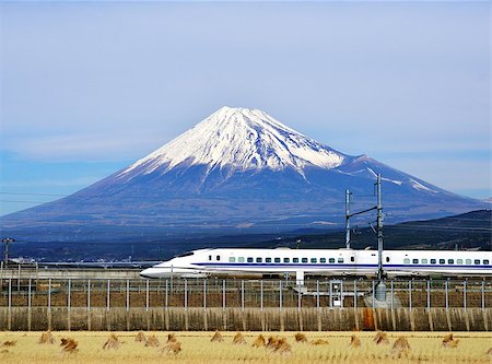 A bullet train passes below Mt. Fuji in Japan. Fotografie stock - Microstock e Abbonamento, Codice: 400-06856518
