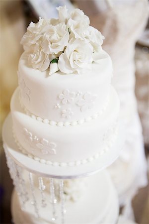 White layered wedding cake with roses, selective focus on roses Stock Photo - Budget Royalty-Free & Subscription, Code: 400-06856671