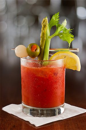 salt rim - bloody mary cocktail isolated on a busy bar top garnished with onions, olives, asparagus and celery Stock Photo - Budget Royalty-Free & Subscription, Code: 400-06856739