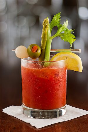 bloody mary cocktail isolated on a busy bar top garnished with onions, olives, asparagus and celery Stock Photo - Budget Royalty-Free & Subscription, Code: 400-06856739