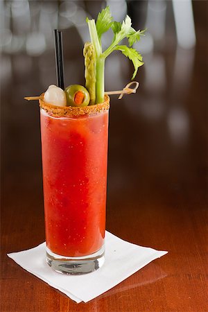 salt rim - bloody mary cocktail isolated on a busy bar top garnished with onions, olives, asparagus and celery Stock Photo - Budget Royalty-Free & Subscription, Code: 400-06856741