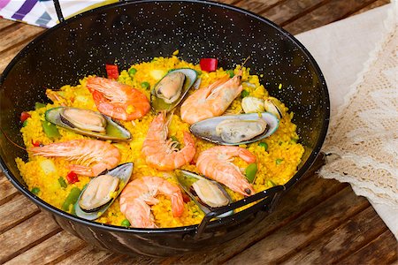 paella pan - Paella in black pan  -traditional spanish rice dish Stock Photo - Budget Royalty-Free & Subscription, Code: 400-06856810