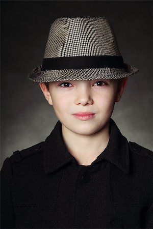 sherlock - Young boy wearing a hat on black background Stock Photo - Budget Royalty-Free & Subscription, Code: 400-06857036