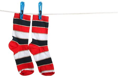 socks hanging clothesline - Pair of striped socks hanging on the clothesline. Image isolated on white background Stock Photo - Budget Royalty-Free & Subscription, Code: 400-06857032