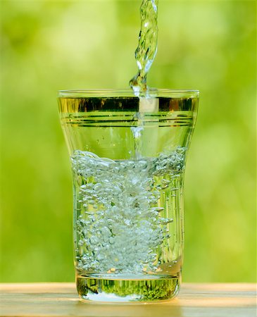 simsearch:400-08815499,k - Pouring Water into a Glass against the Green Nature Background Foto de stock - Royalty-Free Super Valor e Assinatura, Número: 400-06857591