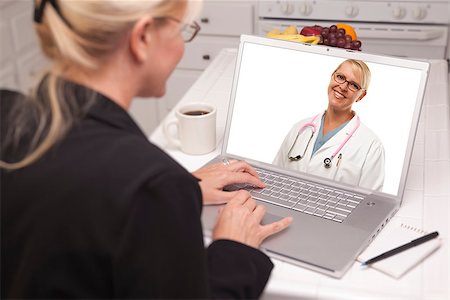 simsearch:400-05129327,k - Woman In Kitchen Using Laptop - Online Chat with Nurse or Doctor on Screen. Stock Photo - Budget Royalty-Free & Subscription, Code: 400-06857711