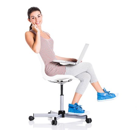 Beautiful student sitting in a chair with a laptop, isolated over a white background Foto de stock - Super Valor sin royalties y Suscripción, Código: 400-06857928