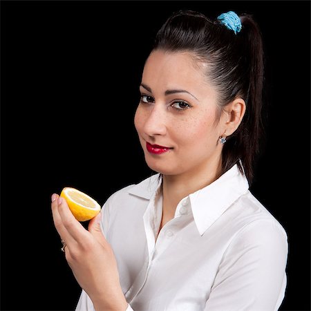 The woman holds in hands a yellow lemon Stock Photo - Budget Royalty-Free & Subscription, Code: 400-06858785