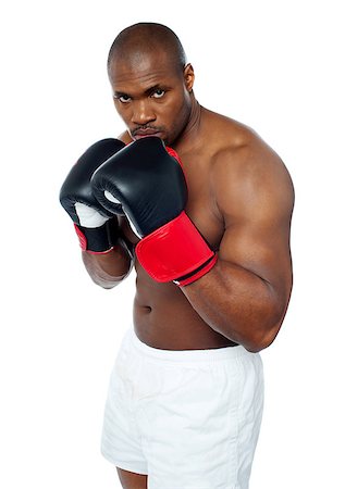 simsearch:400-06859184,k - Shirtless african boxer aiming to punch you. Be alert. Stockbilder - Microstock & Abonnement, Bildnummer: 400-06859196