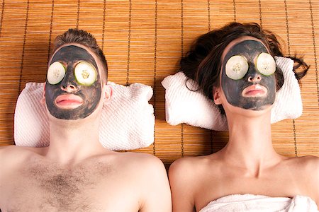 Couples holiday retreat at spa getting facial mask with cucumber skincare relaxing beauty treatment on bamboo. Stock Photo - Budget Royalty-Free & Subscription, Code: 400-06859619