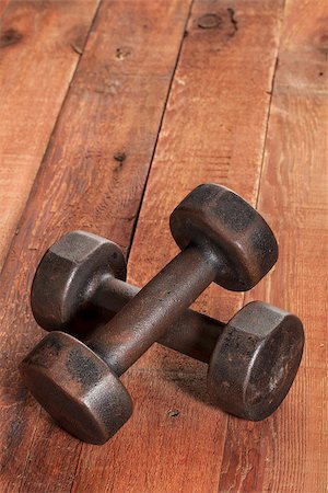 a pair of vintage iron rusty dumbbells on red barn wood background - fitness concept with nostalgic mood Stock Photo - Budget Royalty-Free & Subscription, Code: 400-06850530