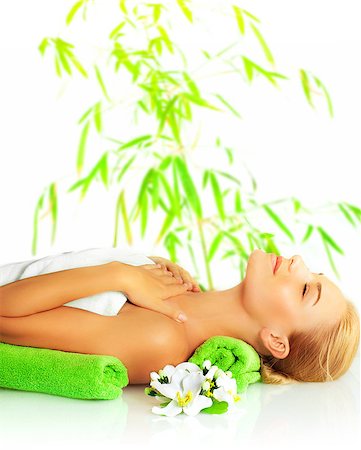 Picture of petty woman in spa salon, cute girl laying down on massage table, beautiful female enjoying dayspa, side view of young lady relaxed in spa over bamboo tree green leaves background Stock Photo - Budget Royalty-Free & Subscription, Code: 400-06851522