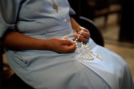 rosario - People and religion, catholic sister praying in church and holding cross in hands. With model release Foto de stock - Super Valor sin royalties y Suscripción, Código: 400-06852480