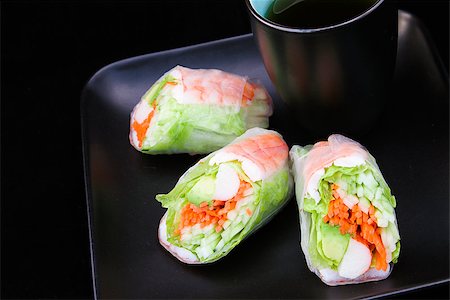 Japanese sushi salad spring rolls on black plate with tea. Stock Photo - Budget Royalty-Free & Subscription, Code: 400-06852694