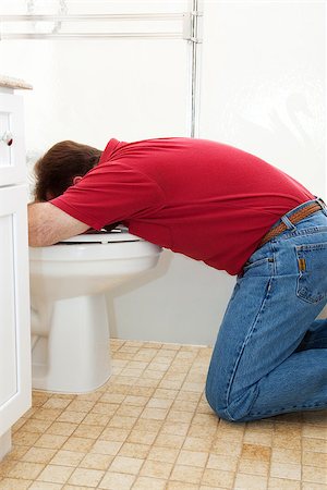 Man in the bathroom, vomiting into the toilet. Stock Photo - Budget Royalty-Free & Subscription, Code: 400-06852699