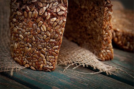 simsearch:400-06416084,k - Rustic loaf of bread with sunflower seeds on wood background Photographie de stock - Aubaine LD & Abonnement, Code: 400-06852719