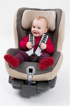 booster seat with child for a car in light background. studio shot Foto de stock - Royalty-Free Super Valor e Assinatura, Número: 400-06852959