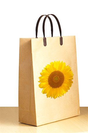 Sunflower paper bag for packing on the white background Fotografie stock - Microstock e Abbonamento, Codice: 400-06852952