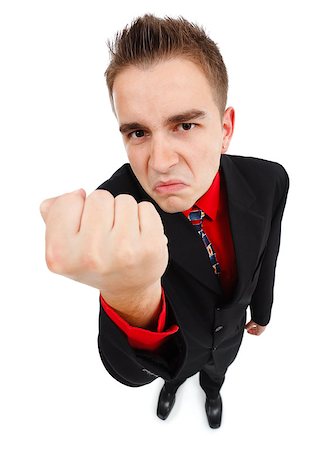 Wide angle view of an angry young man, showing one fist Stock Photo - Budget Royalty-Free & Subscription, Code: 400-06853438